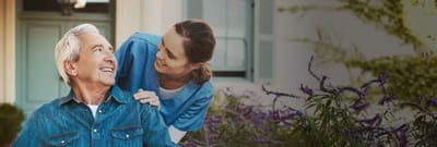 Caregiver interacting with a resident outdoors