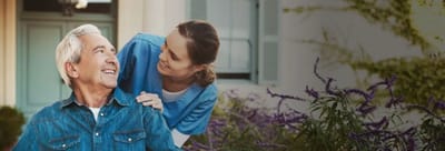 Resident and staff member interacting outdoors