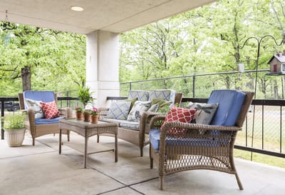 Cozy outdoor seating area with plants and pillows