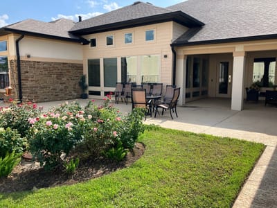 Outdoor seating area with landscaped flowers