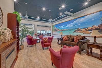 Common area with seating and decorative mural