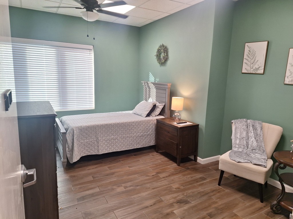 A cozy resident bedroom with natural lighting