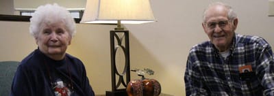 Two residents sitting together in a common area