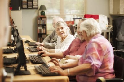 Residents engaging in a computer class at the facility