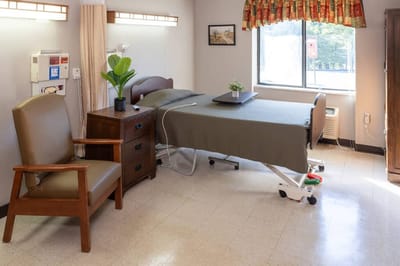 Interior view of a resident's room with a bed and furniture