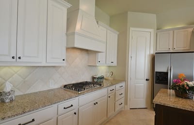 Modern kitchen with white cabinetry and granite countertops