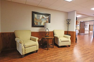 Seating area with chairs and a lamp in a common space
