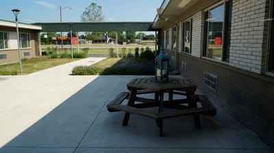 Outdoor picnic table area with landscaping