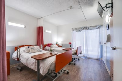 Private resident room with two beds and natural light