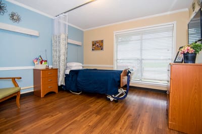 Cozy private resident room with wooden floor and natural light