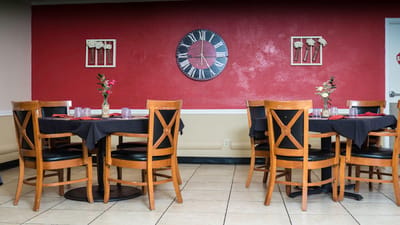 Dining area with wooden tables and decorative wall