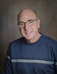 North Big Horn Hospital District, Nursing Home in Douglas, WY — Man smiling in a blue sweater with glasses