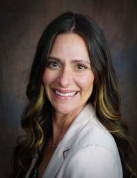 North Big Horn Hospital District, Nursing Home in Douglas, WY — Smiling woman with long hair in a professional setting
