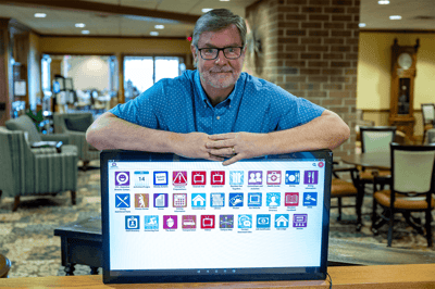 Staff member presenting a digital display in a lounge area