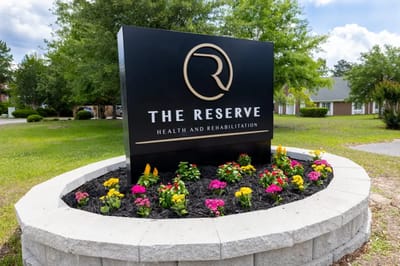 Outdoor facility sign in a landscaped area