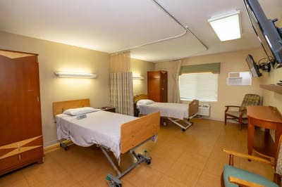 A double resident room with two beds and storage