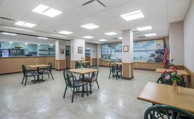 Dining area with tables and murals in the background