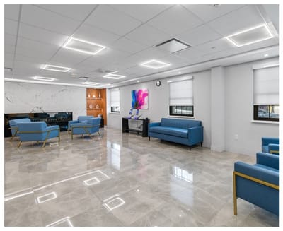 Modern common area with blue seating and natural light