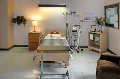A private resident room with a hospital bed and furnishings