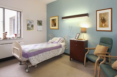 Cozy resident room with a bed and seating area