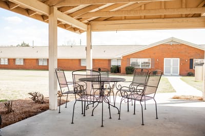 Outdoor seating area with view of the facility building