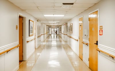 A well-lit corridor in a senior living facility
