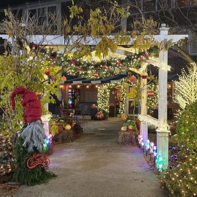 Decorated outdoor entrance with Christmas lights and ornaments