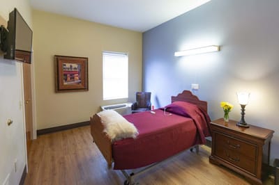 Cozy resident room with a bed and nightstand