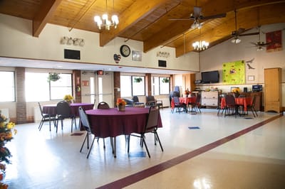 Common area with tables and chairs for residents