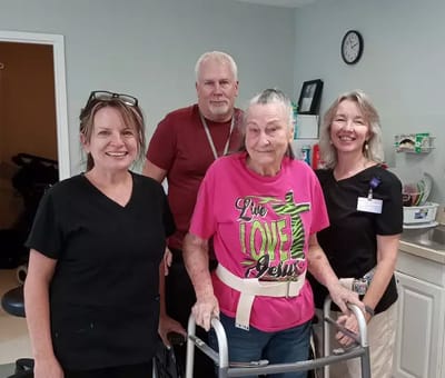 Staff and resident interacting in a care setting.