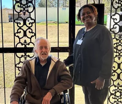 Resident and staff member at the entrance
