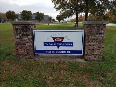 Exterior sign for Pin Oaks Living Center