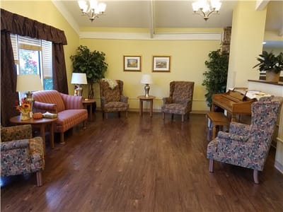 Bright common area with seating and piano