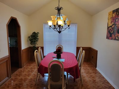 Dining room with a round table and chandelier