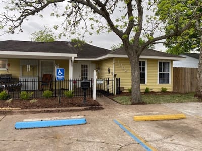 Exterior view of a yellow building with accessible parking