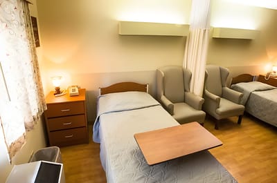 Private resident room with bed and seating area