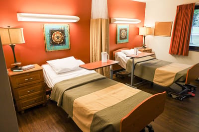 Shared bedroom with two beds and decorative artwork