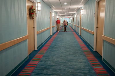 Residents walking in a brightly colored hallway.