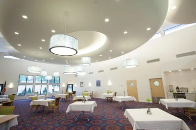 Bright dining room with tables and hanging lights