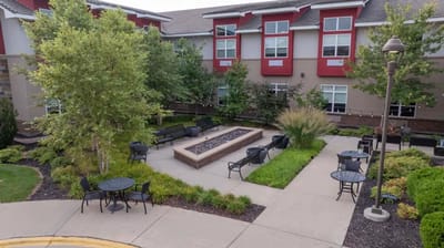 Outdoor seating area with greenery and walking paths