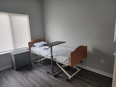 A private resident room with an adjustable bed and table