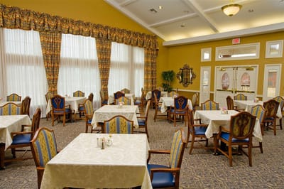 Dining area with tables and chairs decorated in gold and blue
