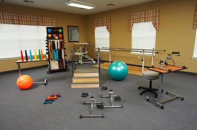 Physical therapy room with various exercise equipment