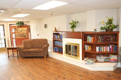 Interior view of a common area with seating and bookshelves