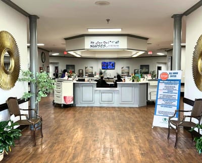 Interior view of a nursing facility reception area with staff and decor