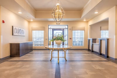 Bright interior lobby with decorative table and flowers