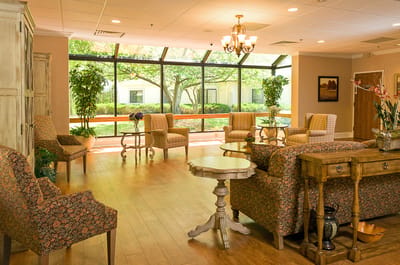 Bright common area with seating and large windows