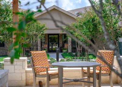 Outdoor seating area with view of the facility entrance