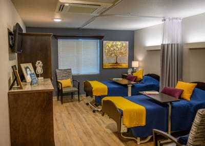 Comfortable resident room with blue bedding and decor