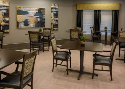 Dining area with tables and artwork on the walls